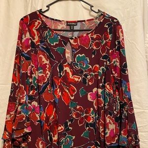 Hip multi-colored flowered dress with quarter length ruffled sleeves by Roz&Ali.